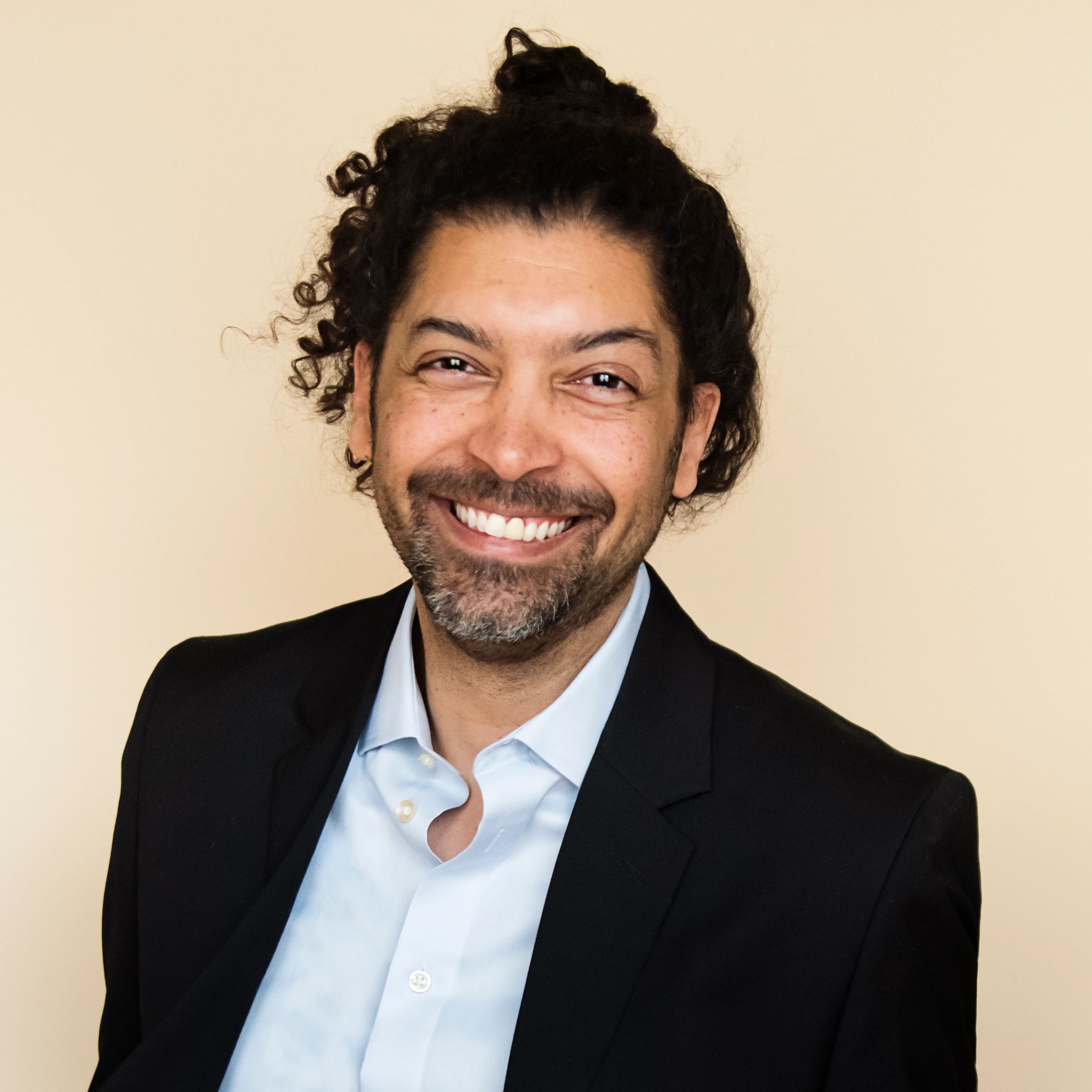 Professional headshot of a smiling man