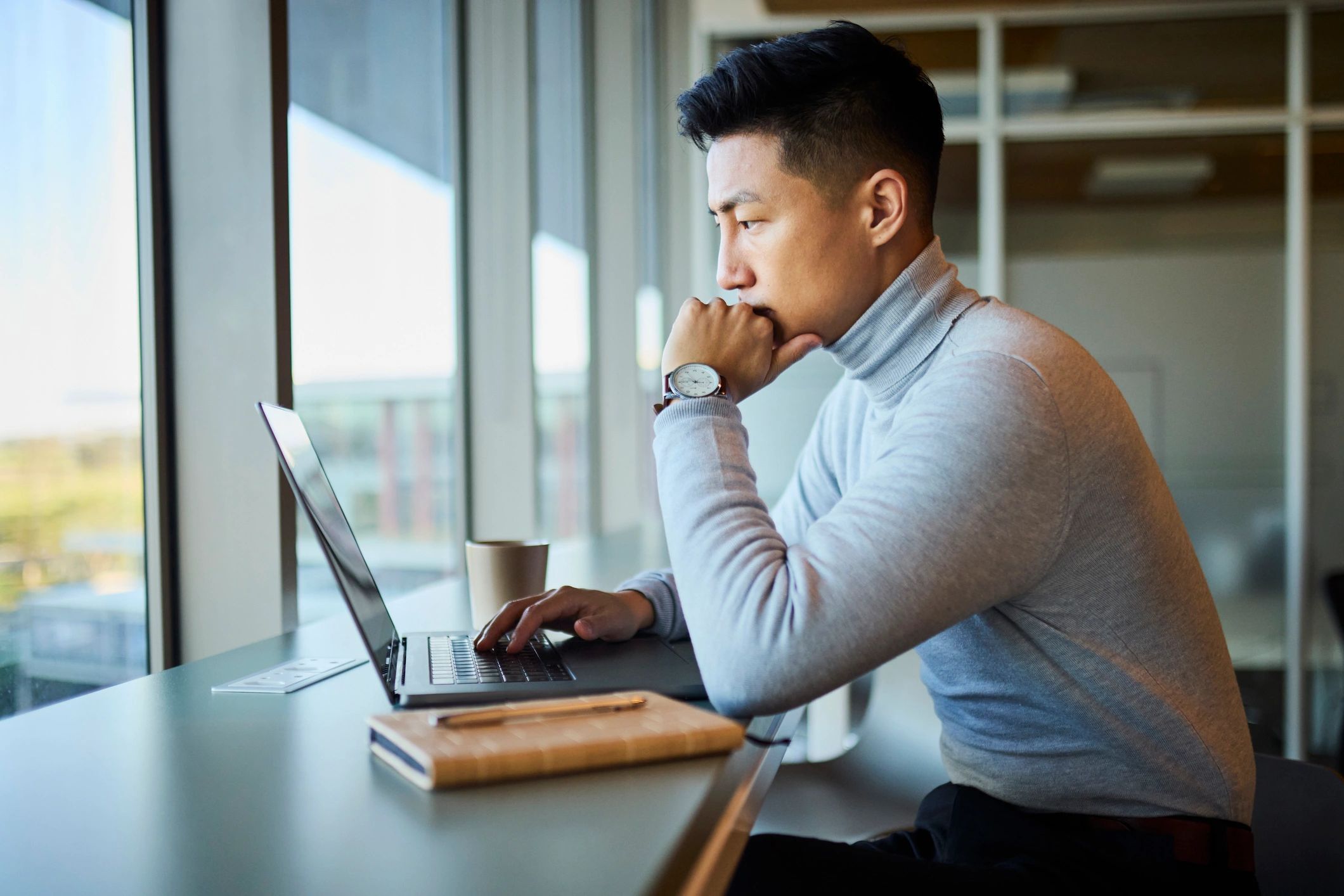 Designer working on a laptop in a modern office